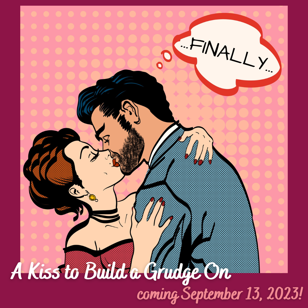 Against a pink and maroon backdrop, a pop-art style illustration of a red-haired white woman in a red dress and a dark-haired, bearded white man in a blue suit, with their arms around each other, locked in a kiss. A thought bubble above the man reads "Finally." And a caption at the bottom reads "A Kiss to Build a Grudge On; Coming September 13, 2023!"